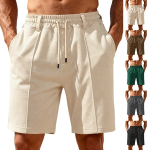 Detail of men's casual drawstring shorts showing waffle texture and multiple color options