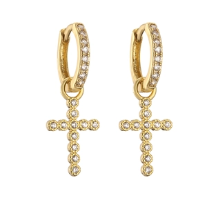Detail of gold huggie hoop earrings with micro-paved zircon cross pendants