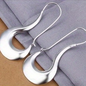 Detailed macro view of silver irregular teardrop earrings with a polished metallic finish