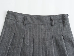 Detailed view of grey pinstripe pleated skirt showing waistband and fabric texture