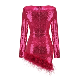 Detail of rose pink sequin party dress featuring a fluffy ostrich feather trim hem