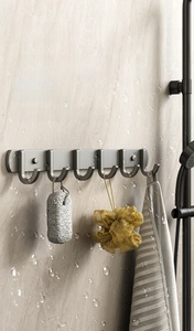 Detail of gunmetal grey bathroom hooks rack with 6 hooks holding a loofah and towel