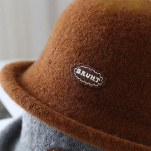 Close-up of caramel wool knit bucket hat featuring soft brushed texture and cloud embroidery