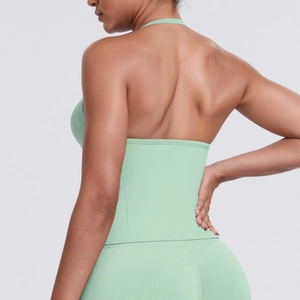 Detailed back view of light green ribbed halter sports top with open back design