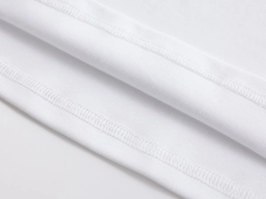 Close-up of double-needle hem stitching on a white ribbed cotton slim-fit T-shirt