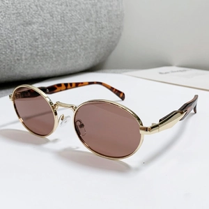 Oval gold metal sunglasses with brown lenses and tortoiseshell temples in a top-down view