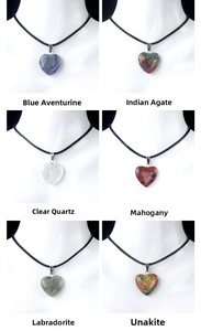 Detail display of six natural gemstone heart pendants with minimalist black cord necklaces