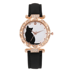 Close-up of rose gold cat motif watch dial with sparkling rhinestone bezel and black strap