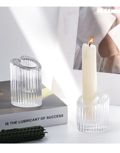Detail of clear ribbed glass candle holder showing elegant vertical texture and soft lighting