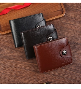 Three men's faux leather wallets in black and brown stacked on a wooden tray with a red ribbon