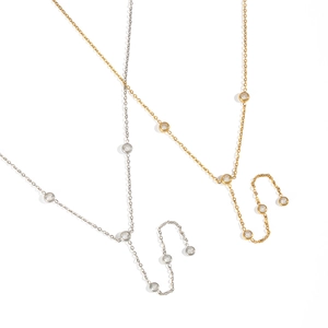 Elegant gold and silver Y-shaped necklaces with zircon stones on white background