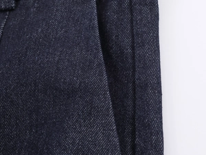 Detail-Makroaufnahme von dunkelindigoblauem Denim-Stoff mit klarer Köperbindung und Baumwolle