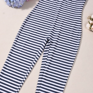 Detailed flat lay of blue and white striped knit jumpsuit with slim fit texture