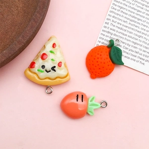 Detail showing resin charms in pizza, orange, and strawberry shapes with metal rings