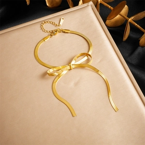 Elegant gold plated stainless steel bowknot snake chain bracelet on silk background