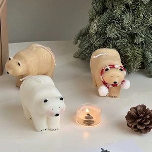 Polar bear candles with pine cones and festive holiday winter atmosphere decorations
