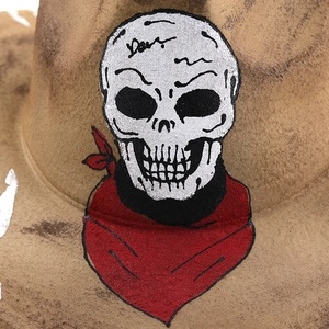 Detail of skull and red bandana embroidery on a khaki cowboy felt hat crown
