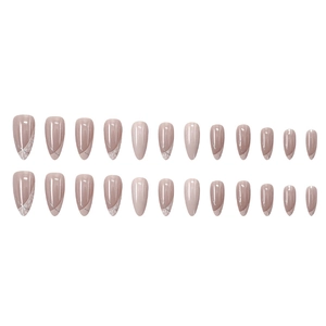 Close-up of almond-shaped press-on nails with nude pink base and silver glitter French tips