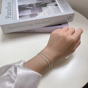 Elegant 925 sterling silver layered bracelet set with delicate beaded chain on wrist