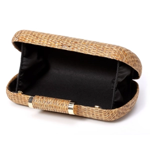 Detailed view of the golden woven texture and black fabric lining of the evening clutch