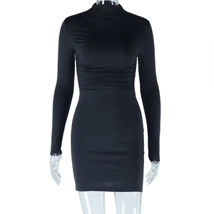 Detail of black mini dress featuring a turtleneck and waist ruching on a white background