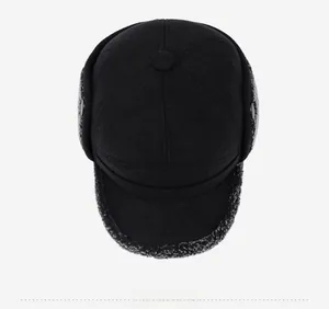 Top-down view of black winter trapper hat with warm grey faux shearling lining