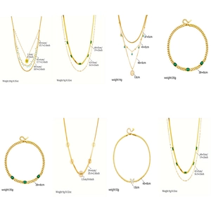 Multi-layer gold chain necklace collection featuring green gemstone and tree of life pendants