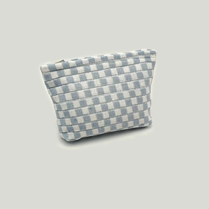 Detail of blue and white checkered knit pouch featuring a sturdy metal zipper closure