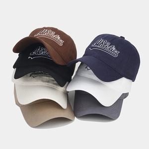 Multiple colors of American vintage embroidery baseball caps stacked on a gray background