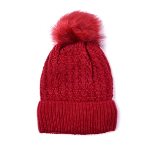 Chunky red knit beanie with faux fur pom-pom and thick cable texture for winter warmth