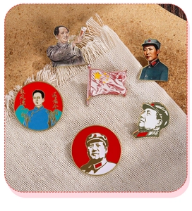 Macro shot of red enamel revolutionary brooches with historic Chinese calligraphy and art