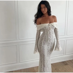 Detailed view of elegant white lace off-shoulder dress with stylish flare sleeves