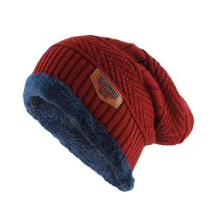 Thick burgundy knit beanie for winter featuring warm fleece lining and leather patch