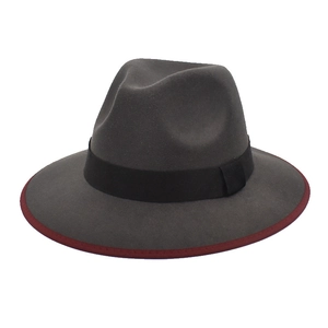 Detail of grey felt fedora featuring black ribbon and deep red contrast edge binding