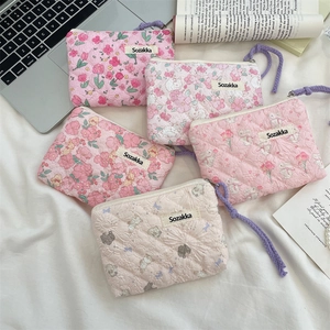 Close-up of floral quilted cotton storage bags in pink and beige with rabbit patterns
