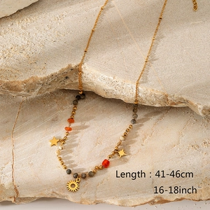 Detail showing colorful natural stone beads and gold pendants on a bohemian necklace