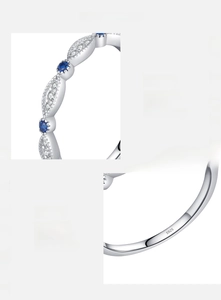 Detailed close-up of S925 sterling silver stamp and sparkling blue cubic zirconia inlays