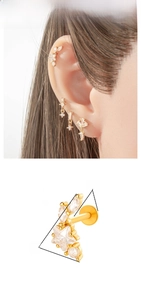 Detailed view of titanium ear studs featuring star designs and inlaid cubic zirconia