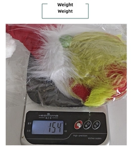 Christmas gnome plush doll weighing 154g on digital scale with red and green fur details