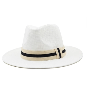 Close-up of the woven texture and black striped ribbon on white straw fedora beach hat