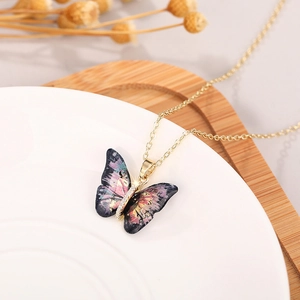 Detailed macro view of colorful butterfly pendant with sparkling micro-inlaid stones