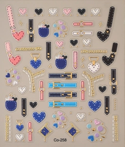 Close-up of heart and chain nail art stickers with gold foil accents for manicure