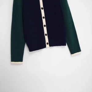 Contrast knit cardigan in dark blue and green with cream trim and button front