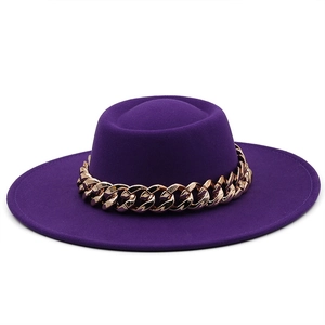 Detail view of purple wool felt fedora featuring a thick gold chunky metal chain link