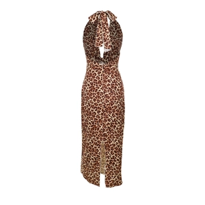 Detail view of leopard print maxi dress featuring high slit and backless halter neck design