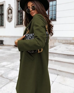 Side view of olive green wool coat showing longline silhouette and fabric drape