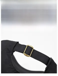 Detail showing back adjustable brass buckle and red embroidery on black sport cap
