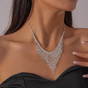 Detail of elegant V-shaped waterfall necklace with sparkling crystal tassels and fringe