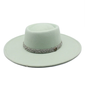 Detailed view of mint green wool felt fedora with rhinestone band and gold M logo buckle