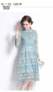 Detail of light blue lace embroidery with beige floral patterns on a slim fit dress